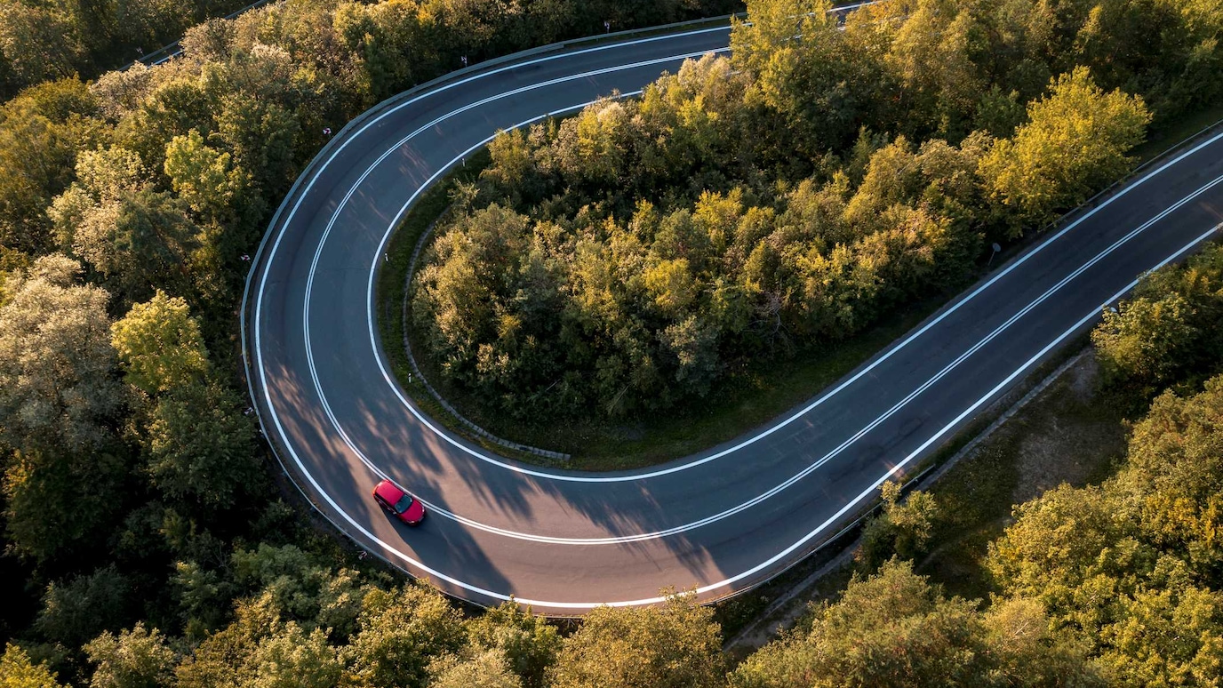 red car winding road