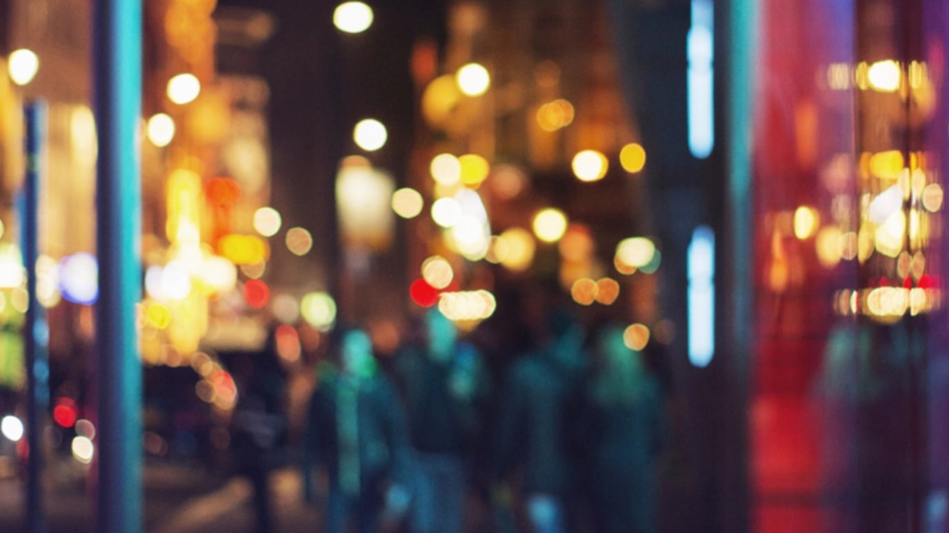 A blurry image of colourful nighttime city lights.