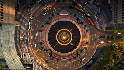 A top-down image of a big roundabout with high-rise buildings on both sides.