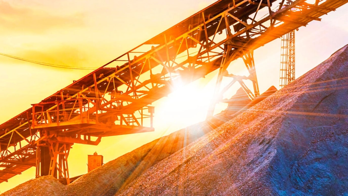 An image of a haulage system on a mountain top with a sunset in the background.