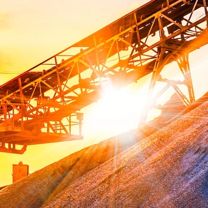 An image of a haulage system on a mountain top with a sunset in the background.