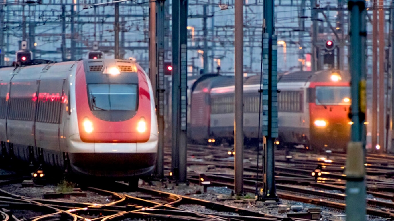 A picture of trains in a rail yard.