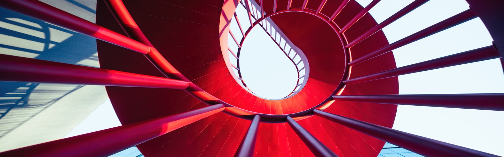 Red spiral staircase seen from underneath