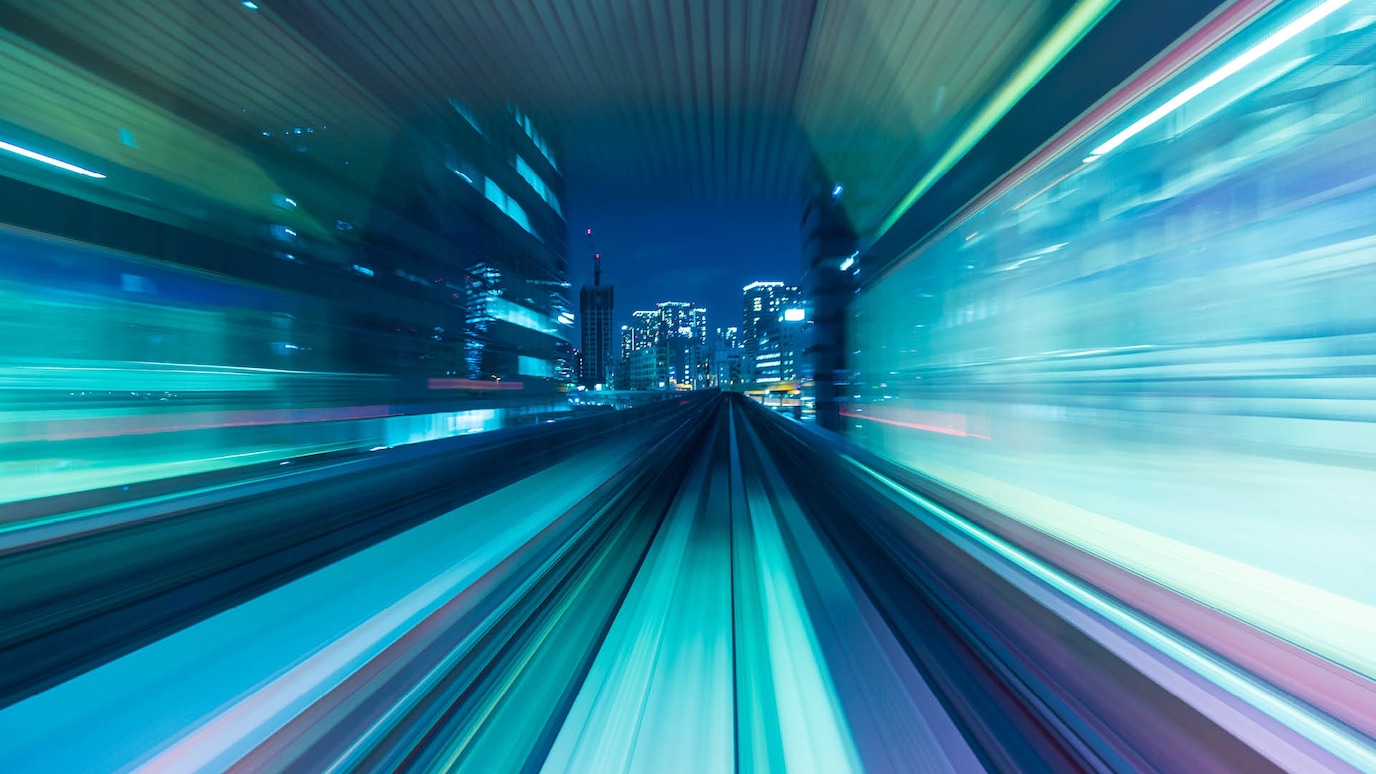 A blurry colourful image of a city at night.