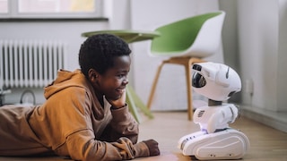 boy interacting with robot