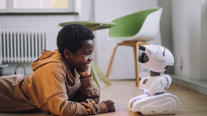 kid playing with robot