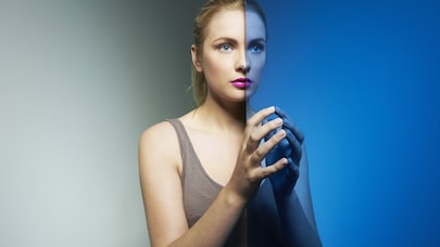 An image of a woman and her reflection.