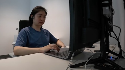 A summer intern working on their computer.