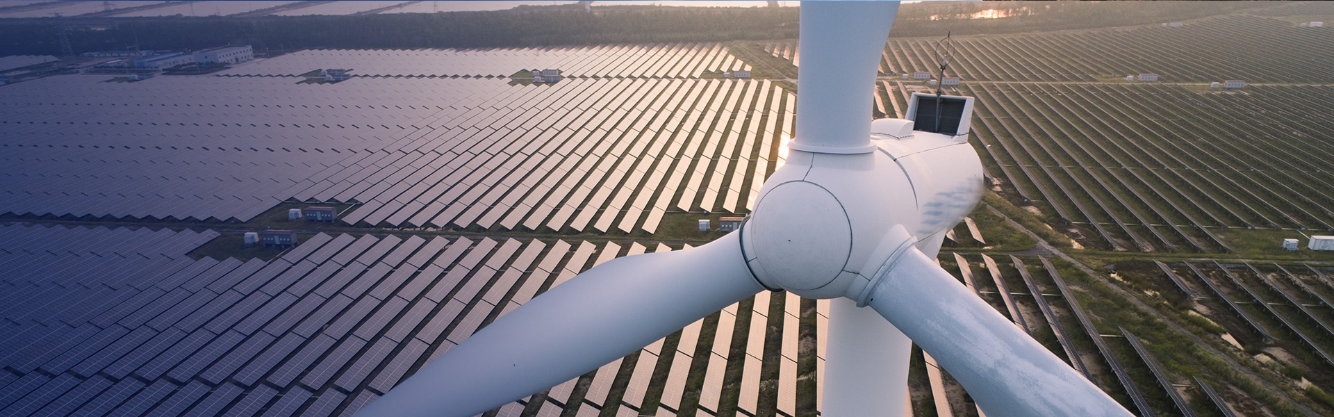 Wind turbine in front of solar farm