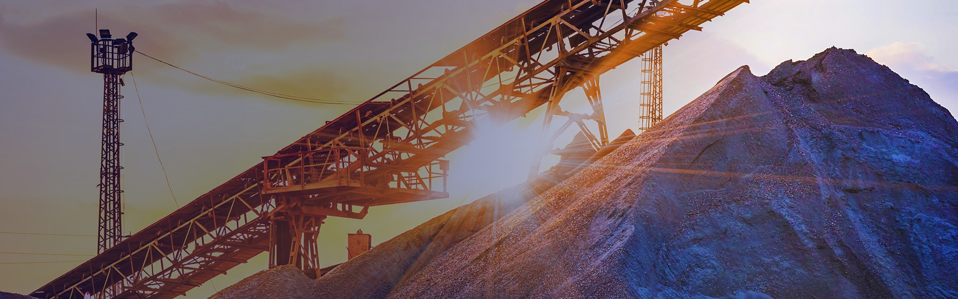 Mining conveyor belt at sunset