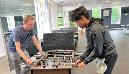 employees playing foosball