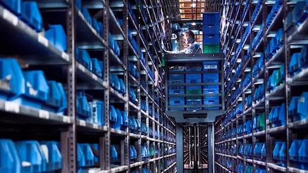 An image with a person working in a warehouse.