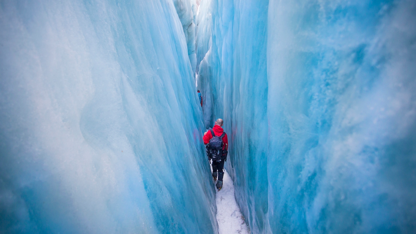 Man hiking in a glacier crevasse