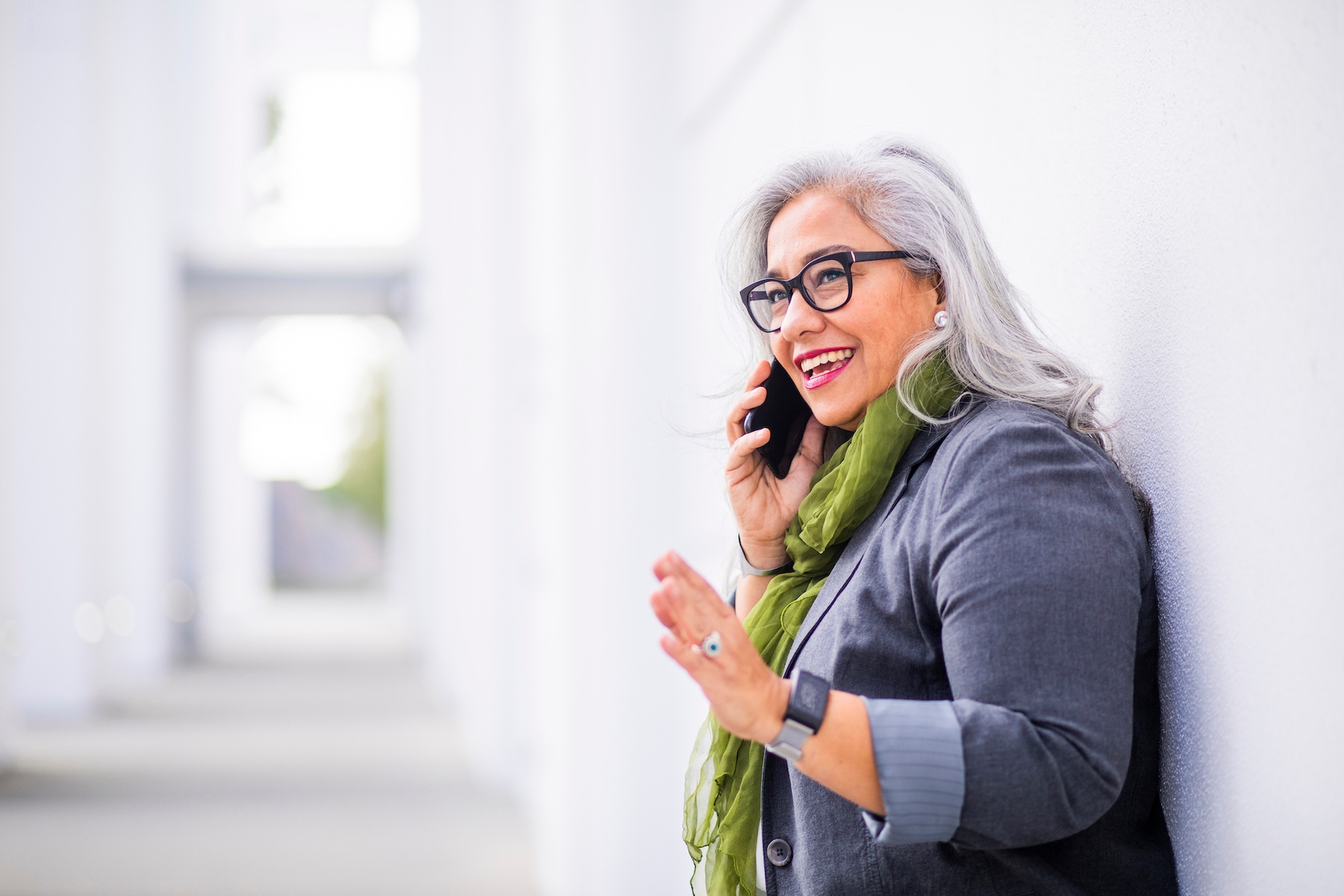 A woman with glasses talking on a mobile phone