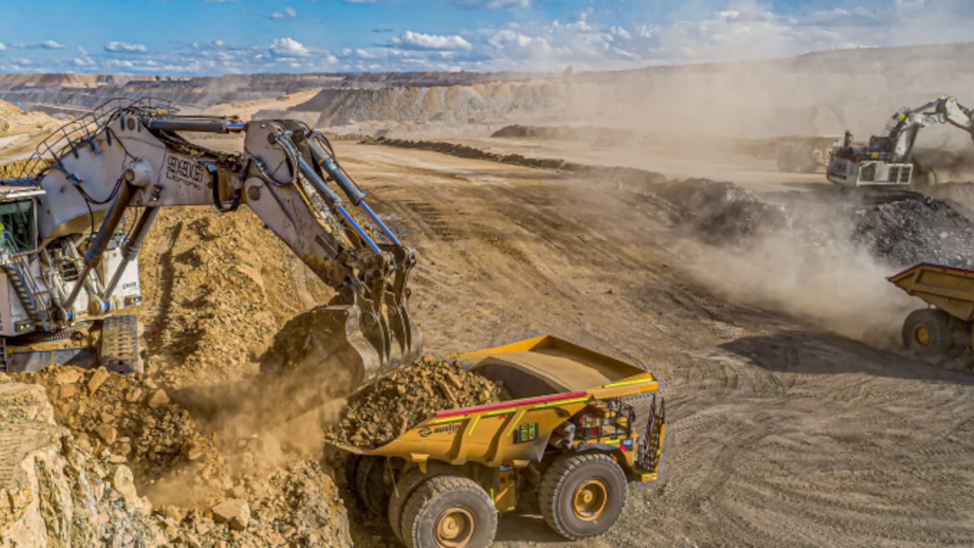 Powerful grabber trucks operating in an open-air mine, adeptly handling materials and contributing to the mining process.