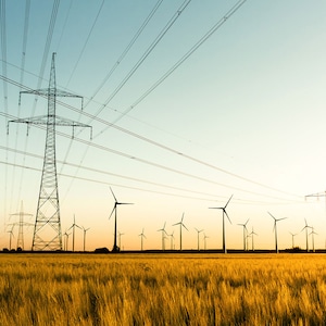 Power pylons and wind turbines in a field