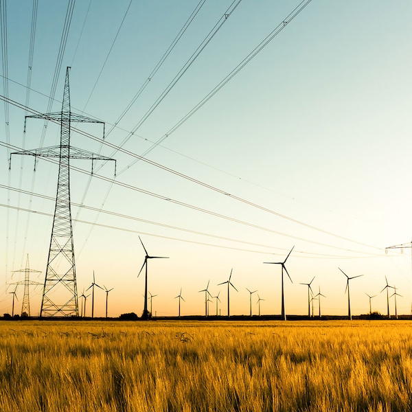 Power pylons and wind turbines in a field