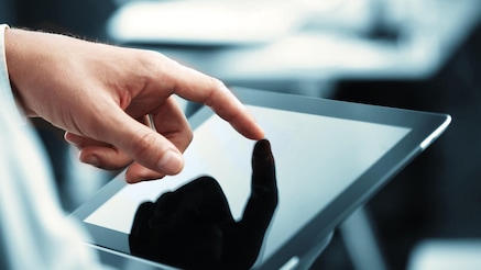 man's hand, finger touching a tablet