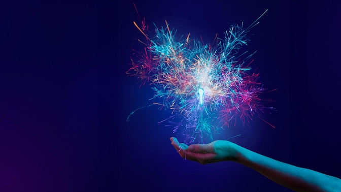 a hand holding a sparkler