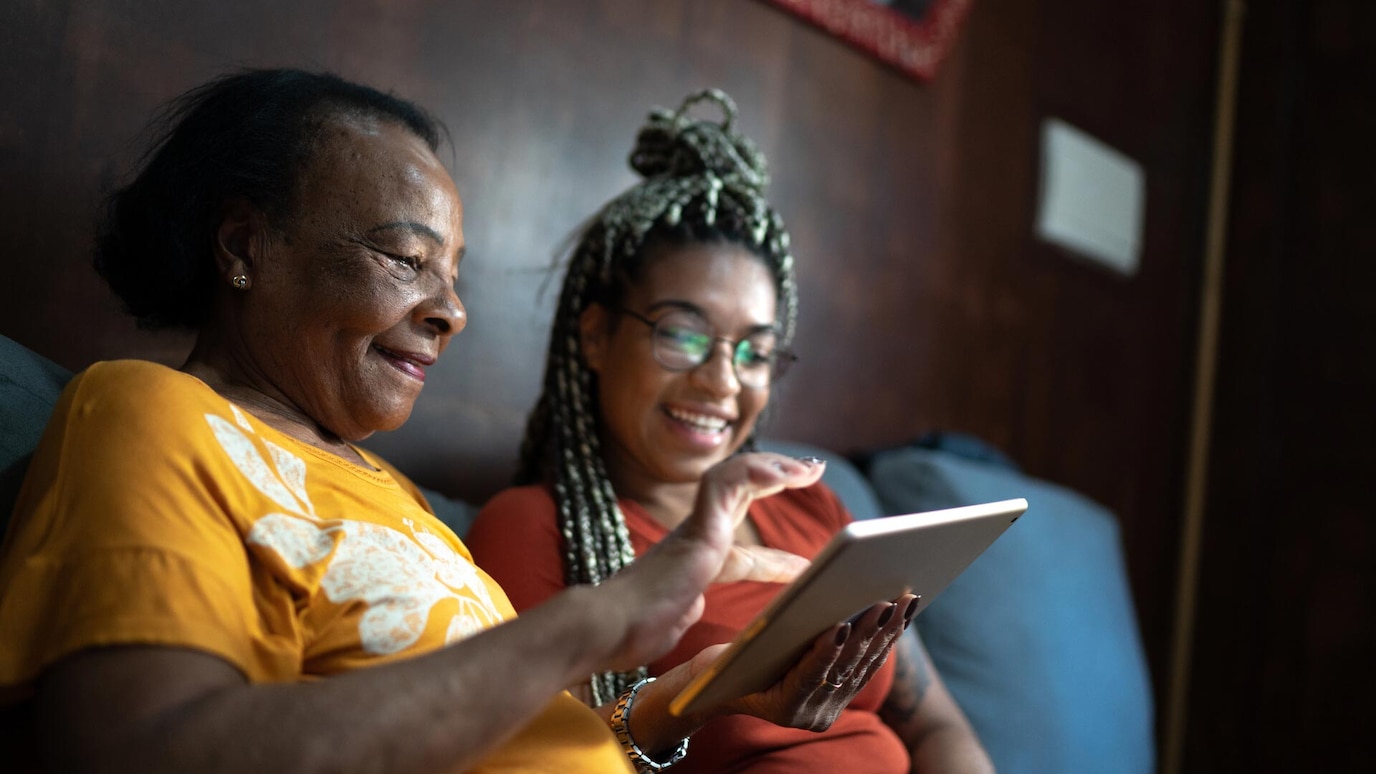 Two women looking at tablet device