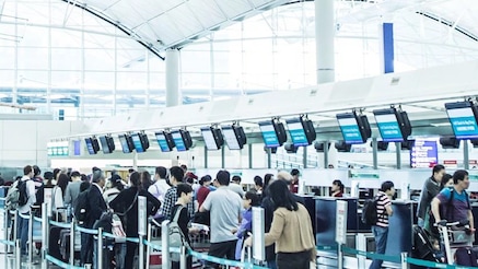 Passengers at an airport check in area