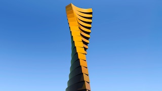 Twisting tower against a blue sky