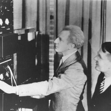 Leopold Stokowski and Harvey Fletcher adjusting the controls on early stereo equipment