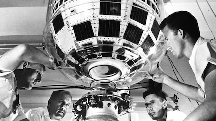 Douglas Aircraft technicians attach communications satellite Telstar