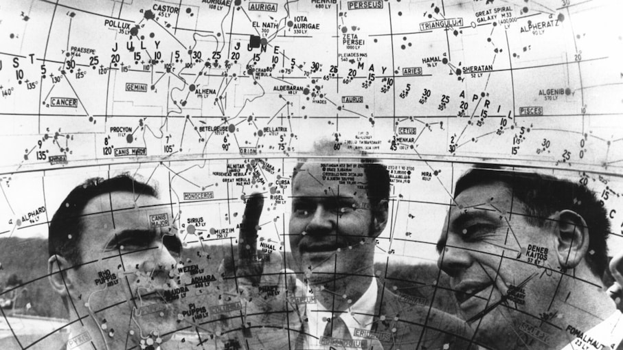 Arno Penzias, Robert Wilson and Keith Jefferts look through a model of the universe to the constellation Orion.