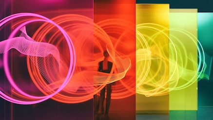 Woman standing among colorful glass screens