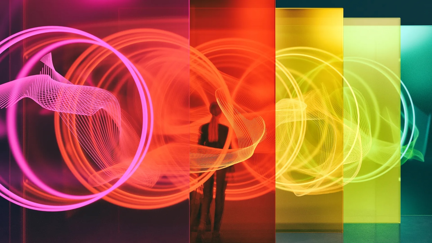 Woman standing amongst colorful screens