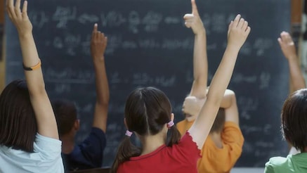 School class with their hands raised