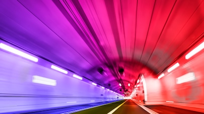 Moving view through lit tunnel