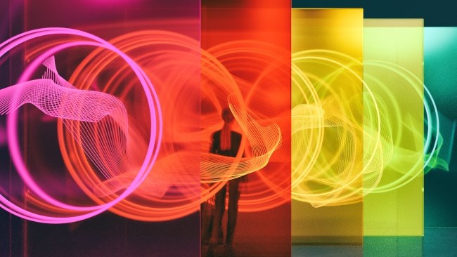 Woman standing amongst colorful light panes