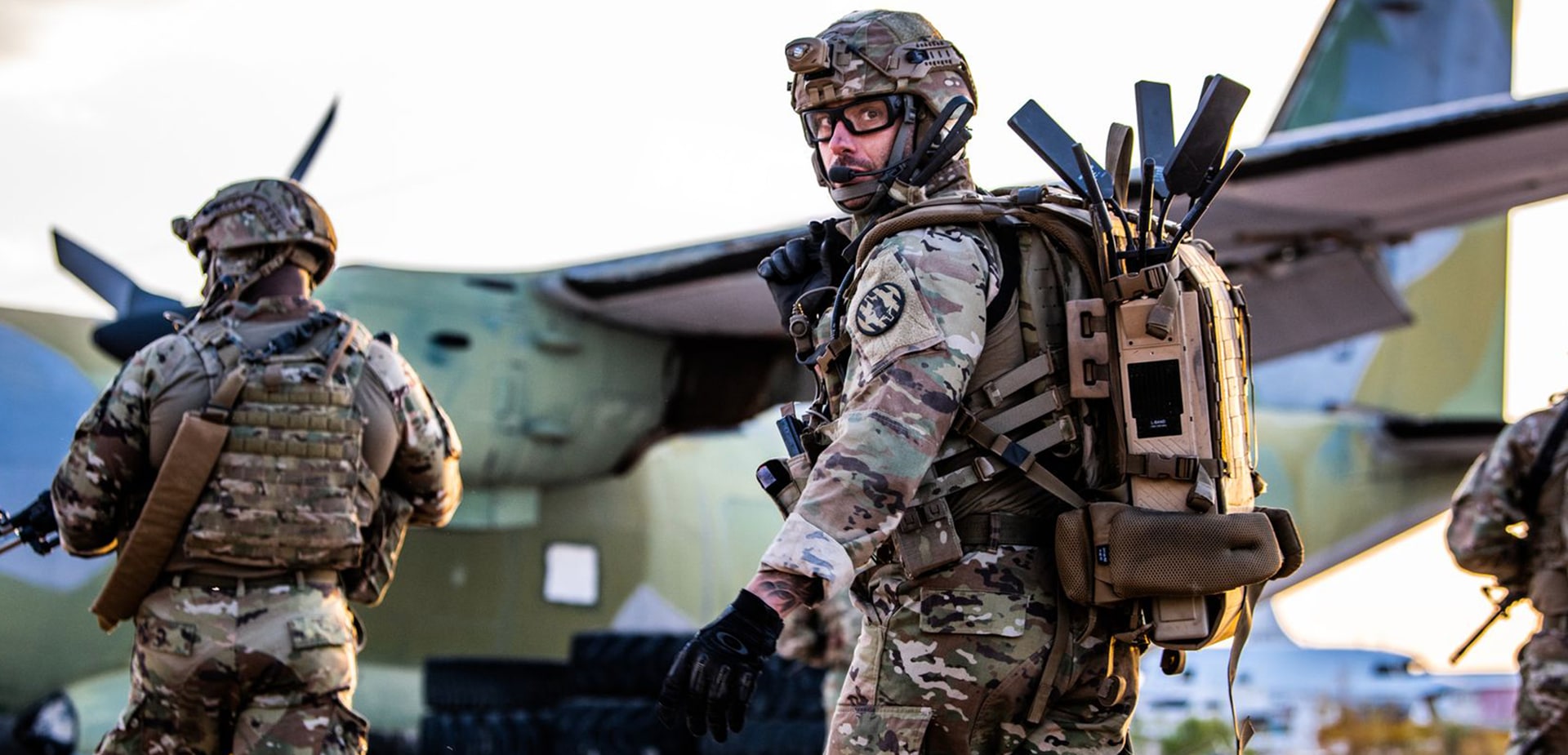 Soldiers standing in front of transporter plane