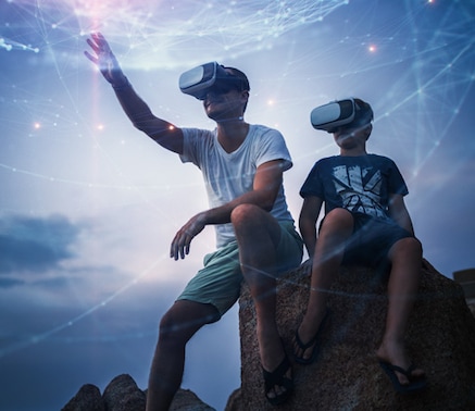 Man and boy wearing VR headsets