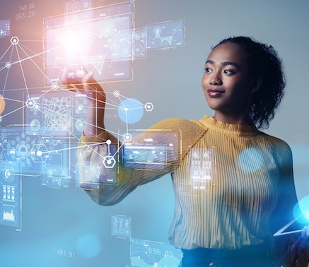 A woman with curly hair standing in front of a futuristic digital display