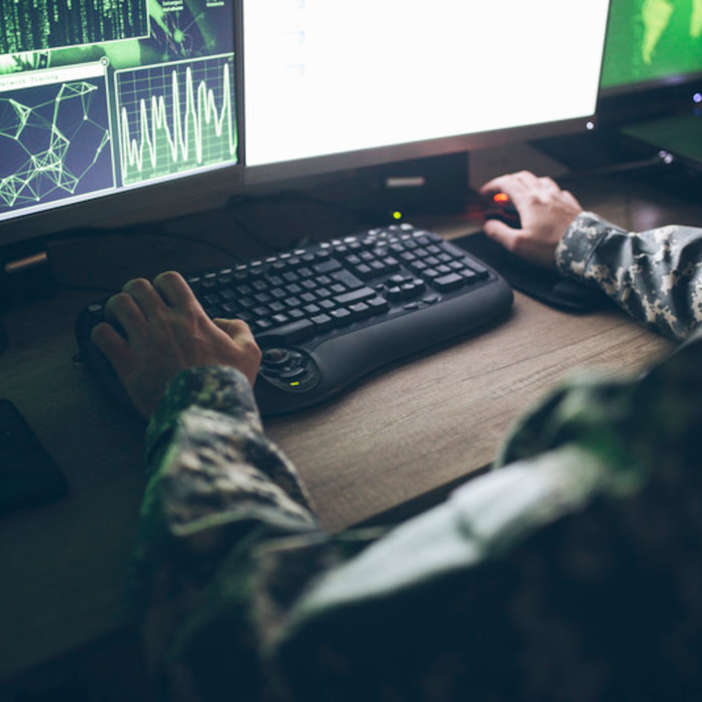 an military officer working in an operations center