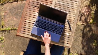 Hand on laptop keyboard