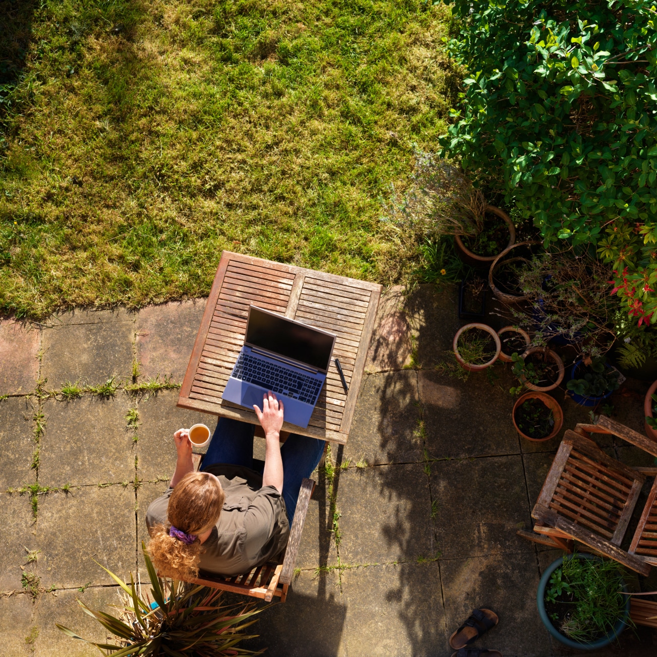 A person with their computer in a garden