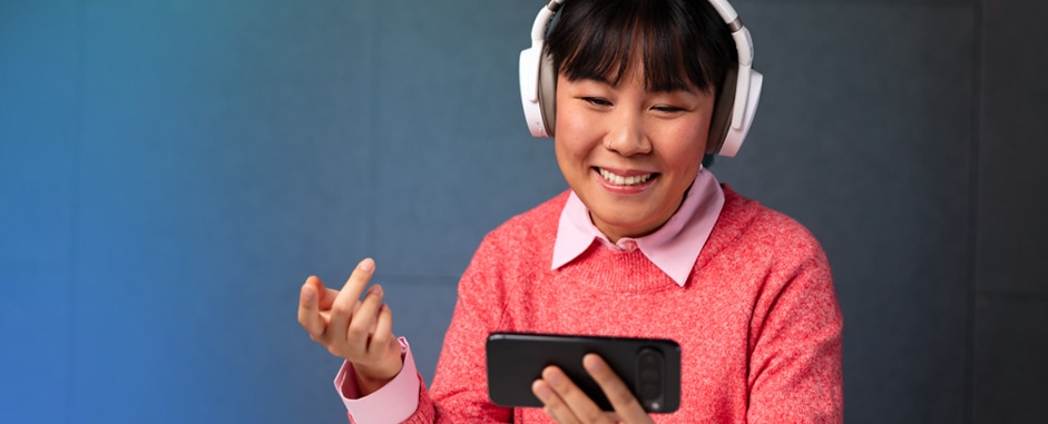 Women listening to an immersive voice call on a smartphone using headphones