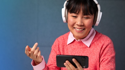 Women listening to an immersive voice call on a smartphone using headphones