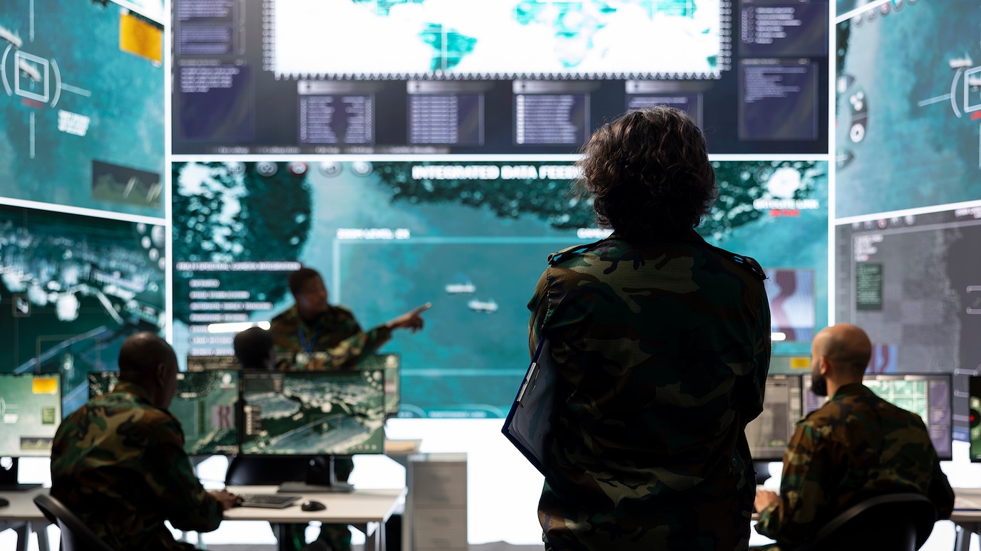 Soldiers viewing screens in smart base