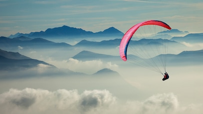 Paraglider in mountainous terrain