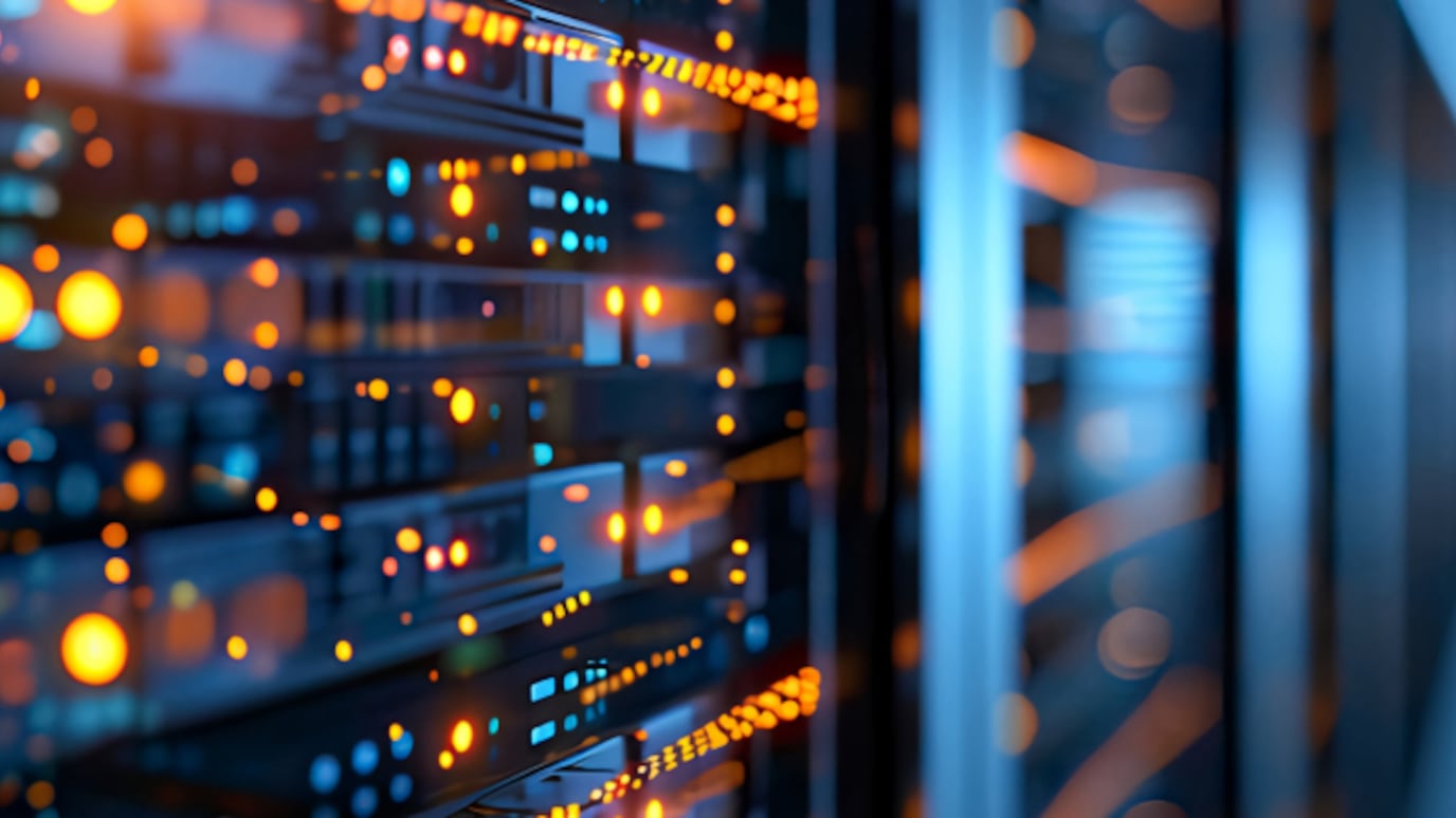 Close-up of illuminated server racks in a modern data center, showcasing cloud computing and secure digital infrastructure.