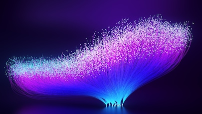 Colorful fiber optic strands glowing in blue, purple, and pink hues on a dark background, representing data or network flow.
