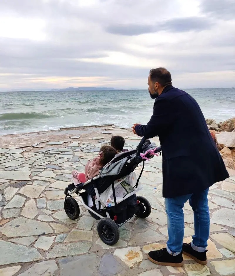 Dimitrios Schoinianakis with his kids at a beach, overlooking the sea.