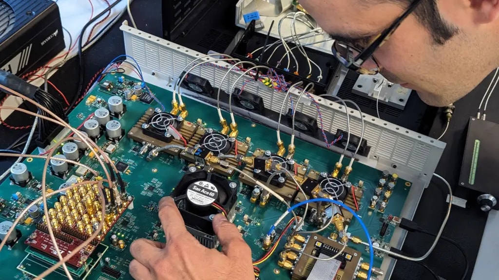 Sylvain Almonacil inspecting an electronic motherboard