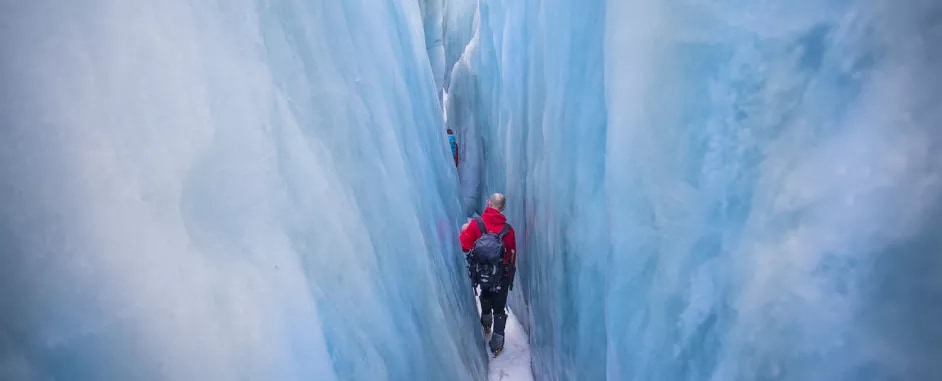 Man hiking in a glacier crevasse