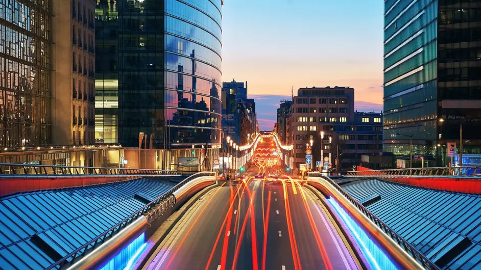 Road with long exposure city lights at night